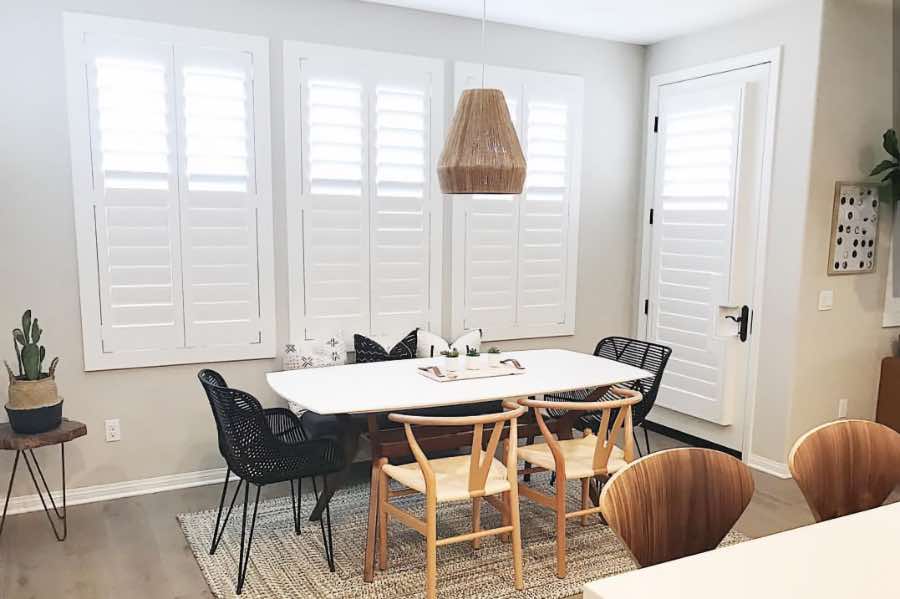 Use Polywood shutters to control natural light levels in your San Diego dining room. Polywood shutters with top louvers tilted open in a dining room
