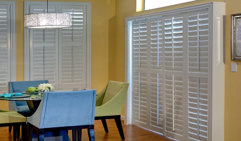 Plantation shutters on a French door function like common window shutters. Patio Doors with Plantation Shutters in San Diego